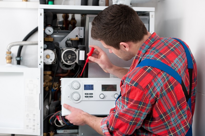 HVAC Technician repairing a HVAC system.